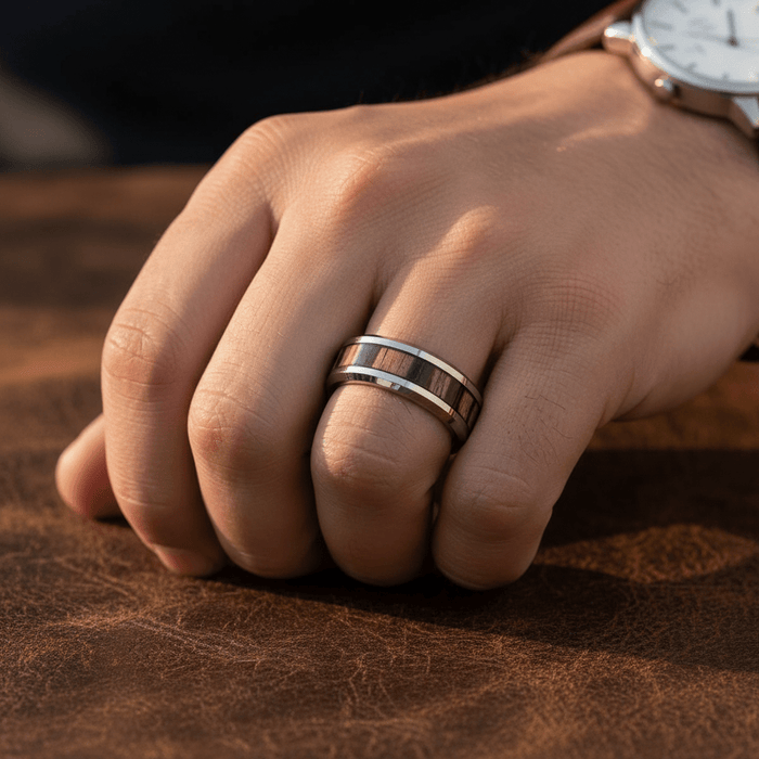 ZEBRINE — Lifestyle photo on hand — men's tungsten wedding ring.